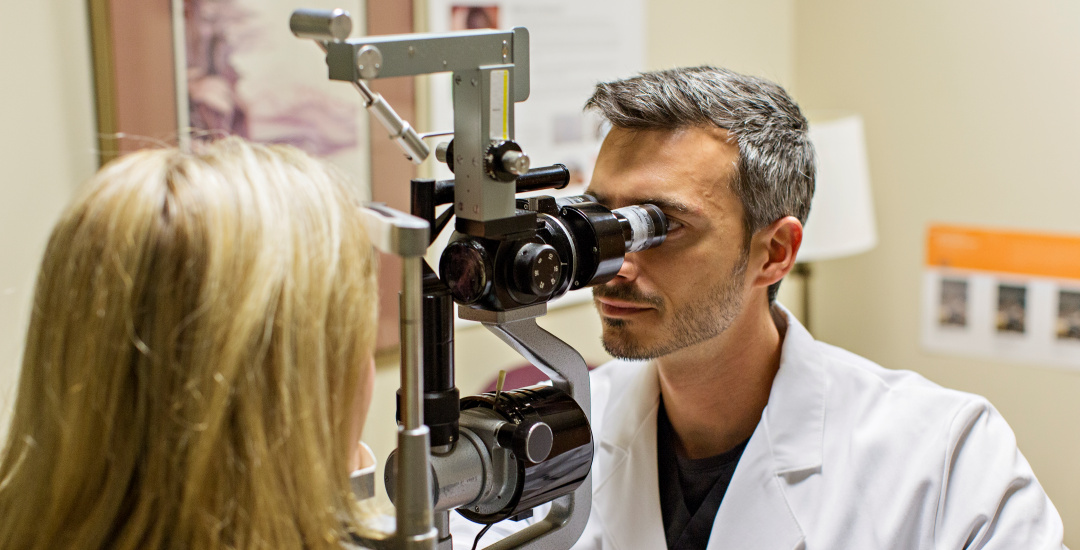 ophthalmologist testing the eyesight of a patient